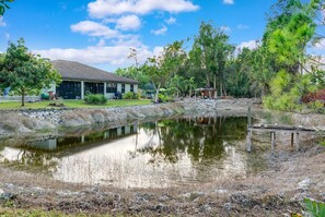 Overlooking a serene lake, this lakeside residence features a dock and a tranquil natural setting.