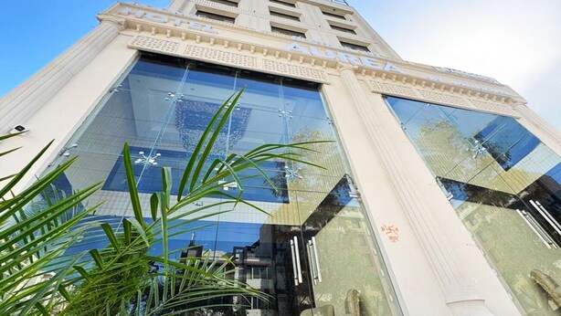 A modern hotel with a glass facade and classical architectural elements. - Aurea by The Wallflower Hotels (Kota)