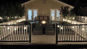 A house with a covered porch, outdoor furniture, and a railing with lights. - Luxurious large estate house in beautiful Alexandria! (Alexandria)