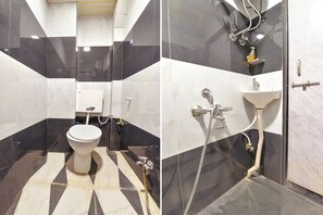 Bathroom features a geometric tile pattern, toilet, sink, and shower area with handheld showerhead.