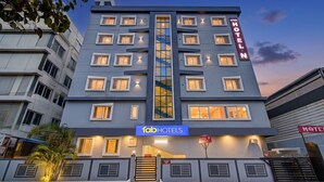 A multi-story hotel with a modern design, featuring a prominent vertical sign for 'HITEX HOTEL' and a horizontal sign for 'fabHOTELS' at the ground level. - FabHotel Hitek N - Nr. Sindhu Hospital and HITEX EXHIBITION CENTER, Hitech City (Hyderabad)