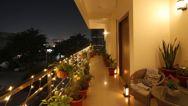 A balcony with potted plants, string lights, and a wicker chair. - Fabhotel Palm Paradise (Noida)