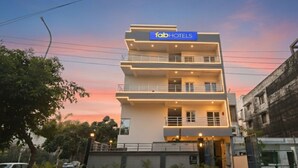 A multi-story building with a sign reading "fab hotels". - Fabhotel Palm Paradise (Noida)