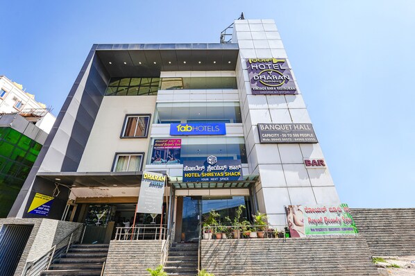 A hotel with multiple signs including 'Dharan Suites', 'Hotel Shreyas Shack', 'Bar', and 'Dharan'. - FabHotel Shreyas Shack (Bengaluru)