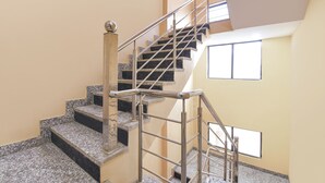A staircase with metal railings and granite steps, leading to a higher floor. - Fabexpress Sr (Jaipur)