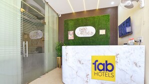 A reception desk with a marble top and a logo for 'fab hotels'. - Fabexpress Sr (Jaipur)