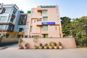 A building with a sign for 'fabHOTELS' and 'RESIDENCY ANGEL GREEN'. - Fabhotel Angel Green Residency (Gurugram)