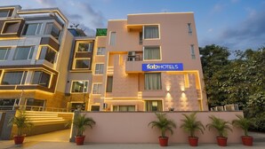 A modern hotel with a sign reading "fabHOTELS" on the facade. - Fabhotel Angel Green Residency (Gurugram)