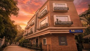 A multi-story building with a brick facade, balconies, and a sign for 'fab hotels'. - Fabhotel Mumbai Corporate Rooms Jb Nagar (Mumbai)