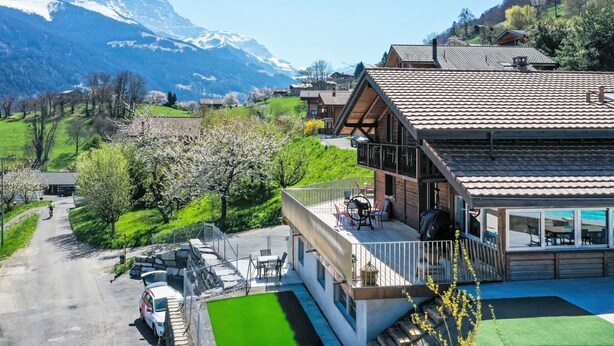 A modern chalet with a balcony, a wooden deck, and a view of snow-capped mountains. - Lau'tentik by Interhome (Collombey-Muraz)