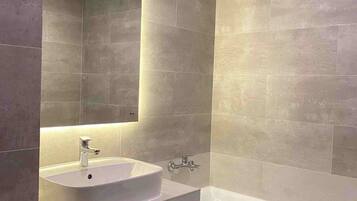 Premier Suite, City View | Bathroom | Hair dryer, slippers, towels, soap