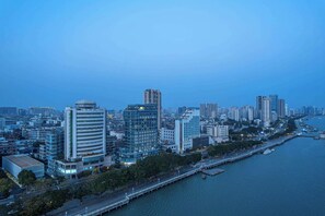 A cityscape with high-rise buildings, a waterfront, and a bridge. - Days Inn by Wyndham Shantou Jinping (Shantou)