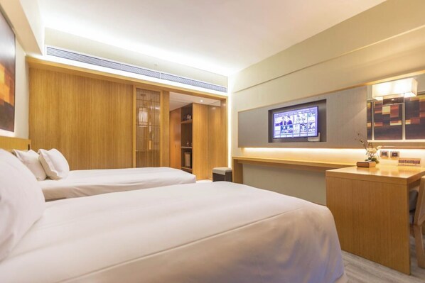 A hotel room with two beds, a desk, a television, and a wooden wardrobe. - SSAW Boutique Hotel Hangzhou Xixi NanLu - Close to Xixi Wetland Area (Hangzhou)