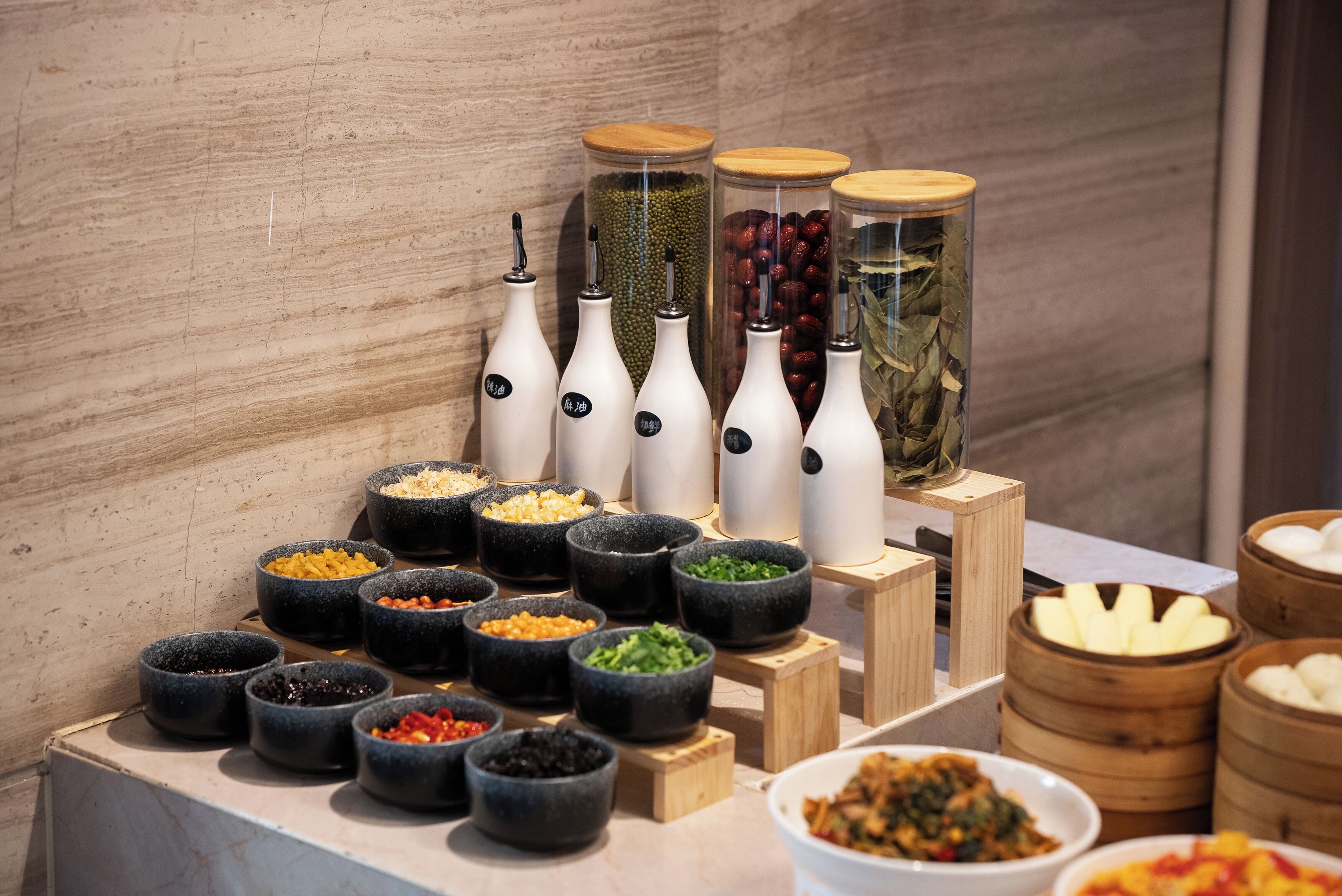 A buffet with various food items and condiments.