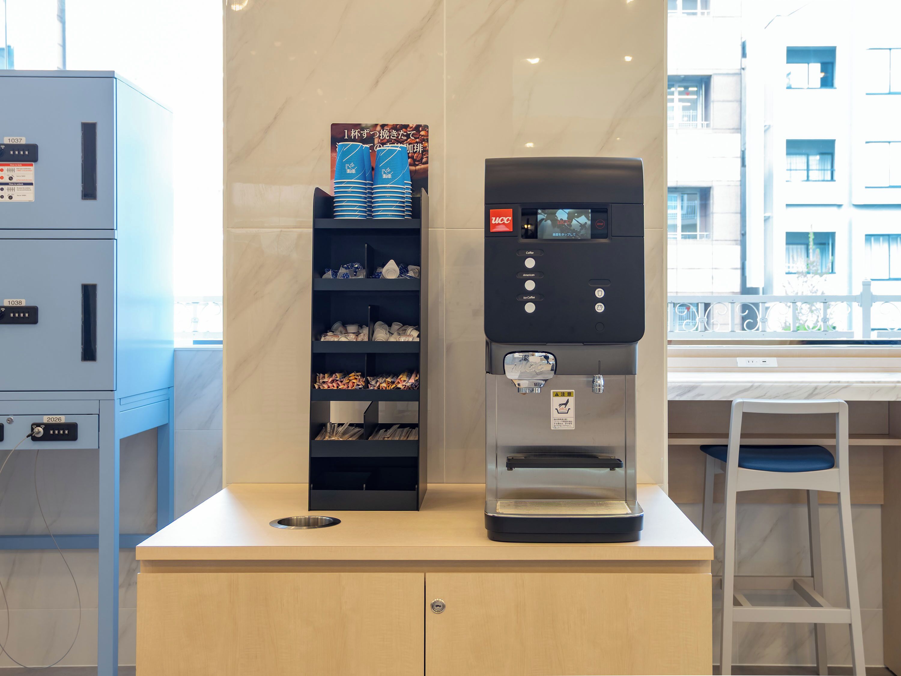 A coffee machine and a shelf with various items in a modern setting.