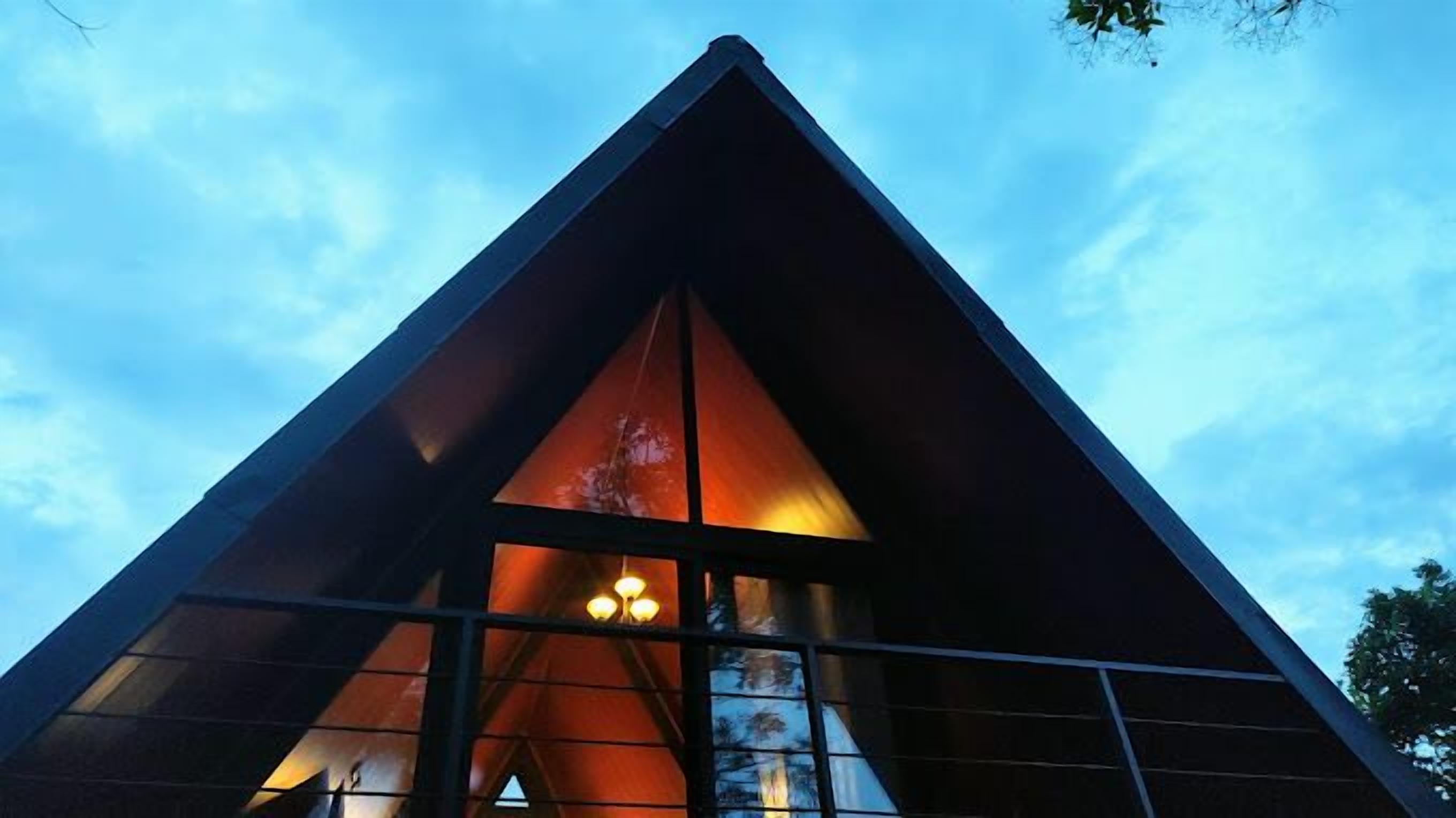 A modern building with a triangular roof and large windows.