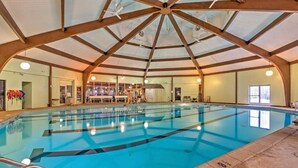 An indoor swimming pool with clear lanes, a high wooden ceiling, and a view of the adjacent room. - The Hangout Haven - theater, pickleball, ping pong, hot tub, karaoke, games (Long Pond)