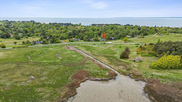 An aerial view of a rural area with a small body of water, green fields, and scattered houses. - "Hjalmine" - 225m from the sea by Interhome (Gørlev)