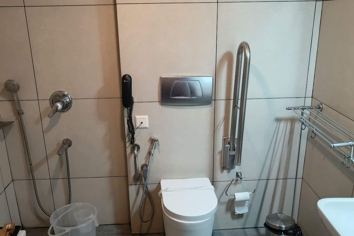 A modern bathroom with a toilet, bidet, and shower.