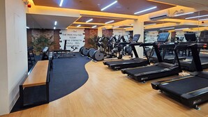 A gym with treadmills, stationary bikes, and weight machines.