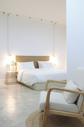 A bedroom with a bed, bedside tables, a chair, and a lamp. - LFOUR  (Phuket)