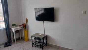 Family Apartment, City View | Living area | Smart TV