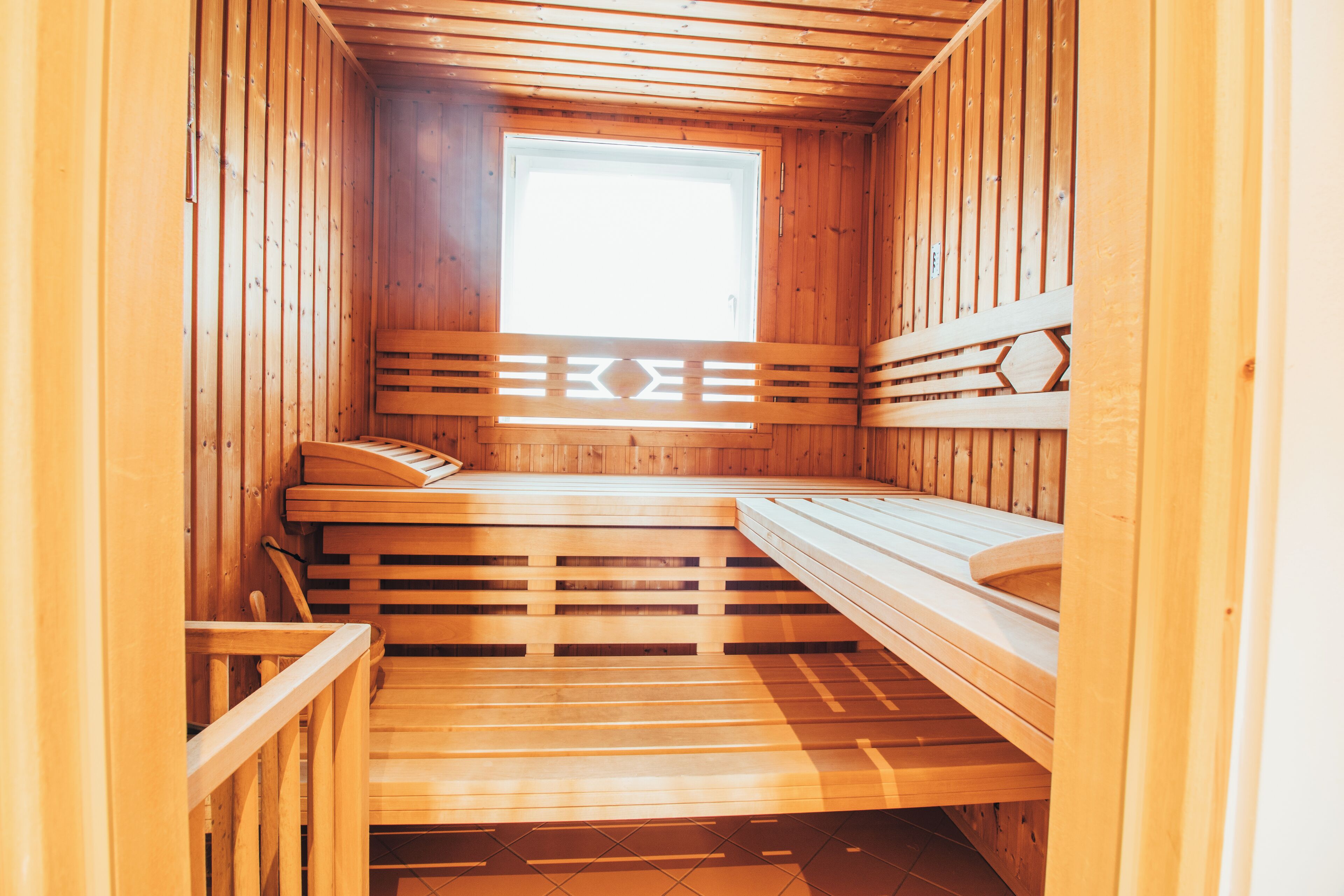 A sauna with wooden benches and a window.