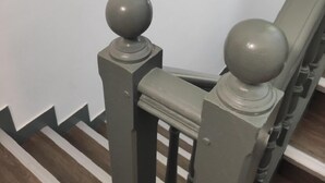 A staircase with a metal railing and wooden steps. - Le Palmier (Saint-Denis)