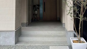 A building entrance with a white awning displaying the logo and name "Mito Onomichi". - MitO Onomichi (Onomichi)