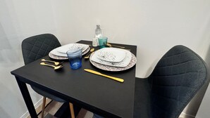 A dining table set with plates, cutlery, and a blue glass. - Casa Angela by Ca-sa Check (Chioggia)