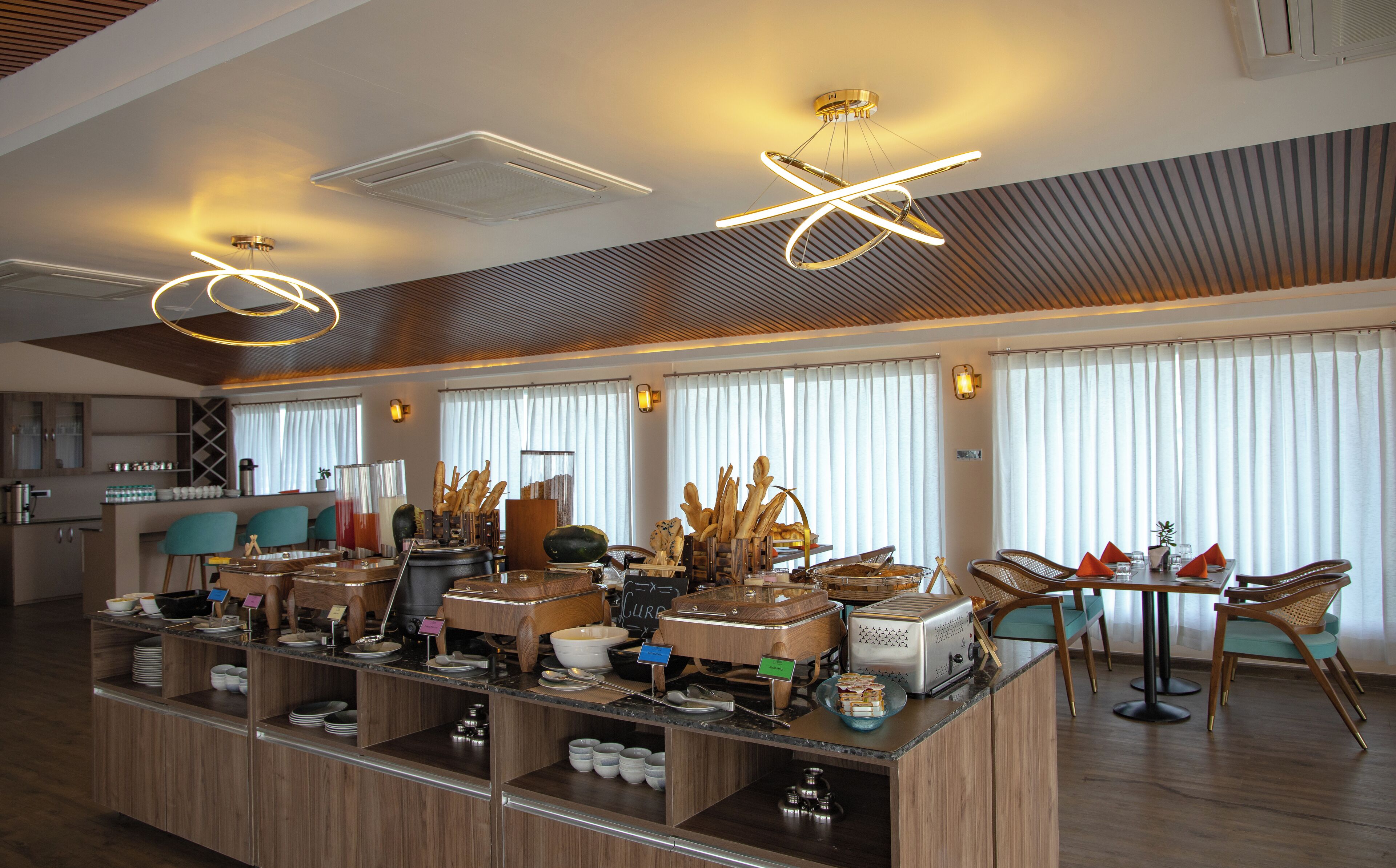 A modern breakfast bar with a variety of food items and a coffee machine.