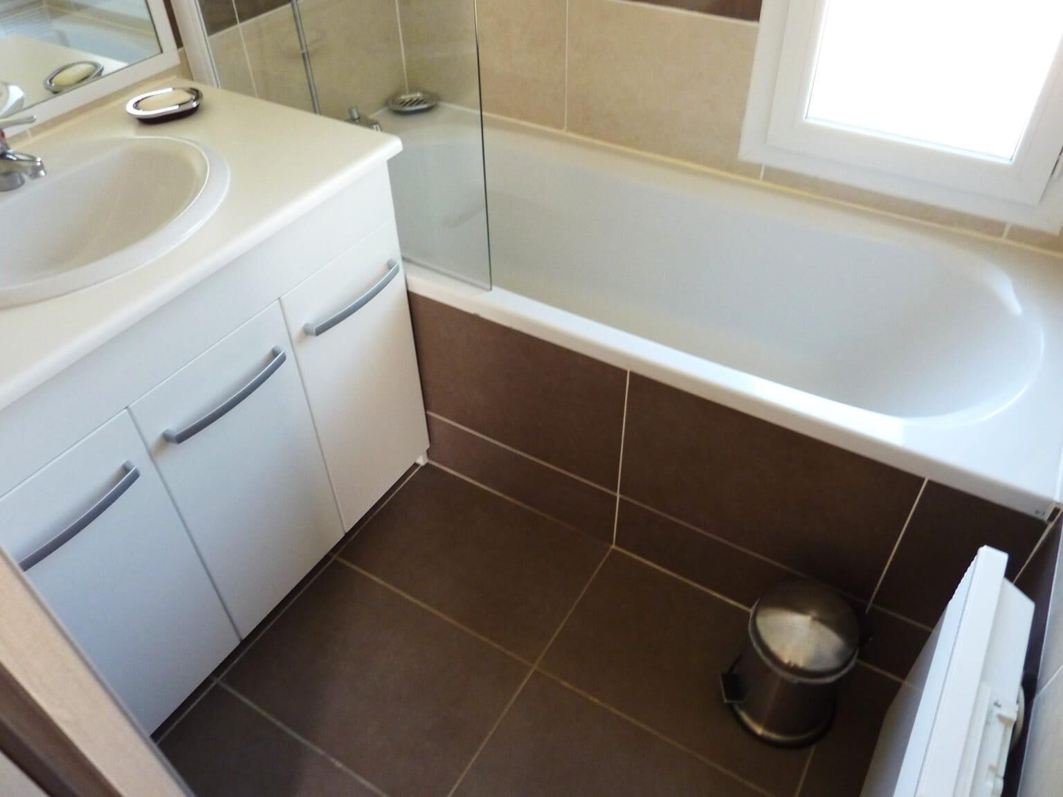 A bathroom with a bathtub, a sink, and a toilet.