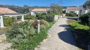 A pathway leading to a row of houses with a clear sky above. - Charming Villa 4 pers swimming pool terrace 600 m from the beach (Belgodère,)