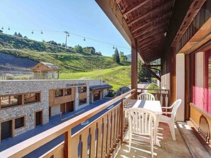 Enjoy breathtaking mountain views from the balcony with a table and chairs.
