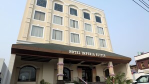 A multi-story hotel with a beige facade, large windows, and a sign reading 'HOTEL IMPERIA SUITES.' - Hotel Imperia Suites (Jalandhar)