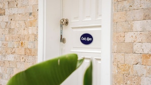A white door with a metal handle and a blue sign that reads "Ceviz Ağac". - Anzede Konaklama Çeşme (Çesme)