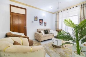Classic Apartment, Balcony | Living area | 24-inch Smart TV with digital channels - Lux Suites Rosavosa Apartments Bamburi (Mombasa)