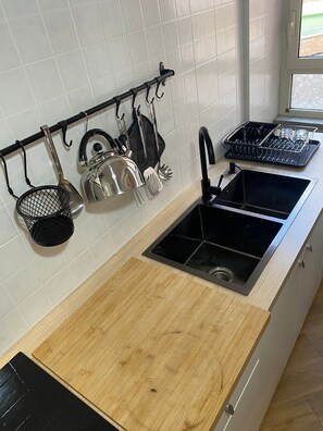Fridge, stovetop, coffee/tea maker, cookware/dishes/utensils