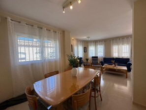 A dining area with a table and chairs, a sofa, and a coffee table. - Spectacular villa in Las Tres Calas (Ametlla de mar)