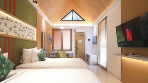 A modern hotel room with a large bed, a TV mounted on the wall, a desk with a chair, and a window with blinds. - Moritz Hill Borobudur Resorts & Spa (Borobudur)