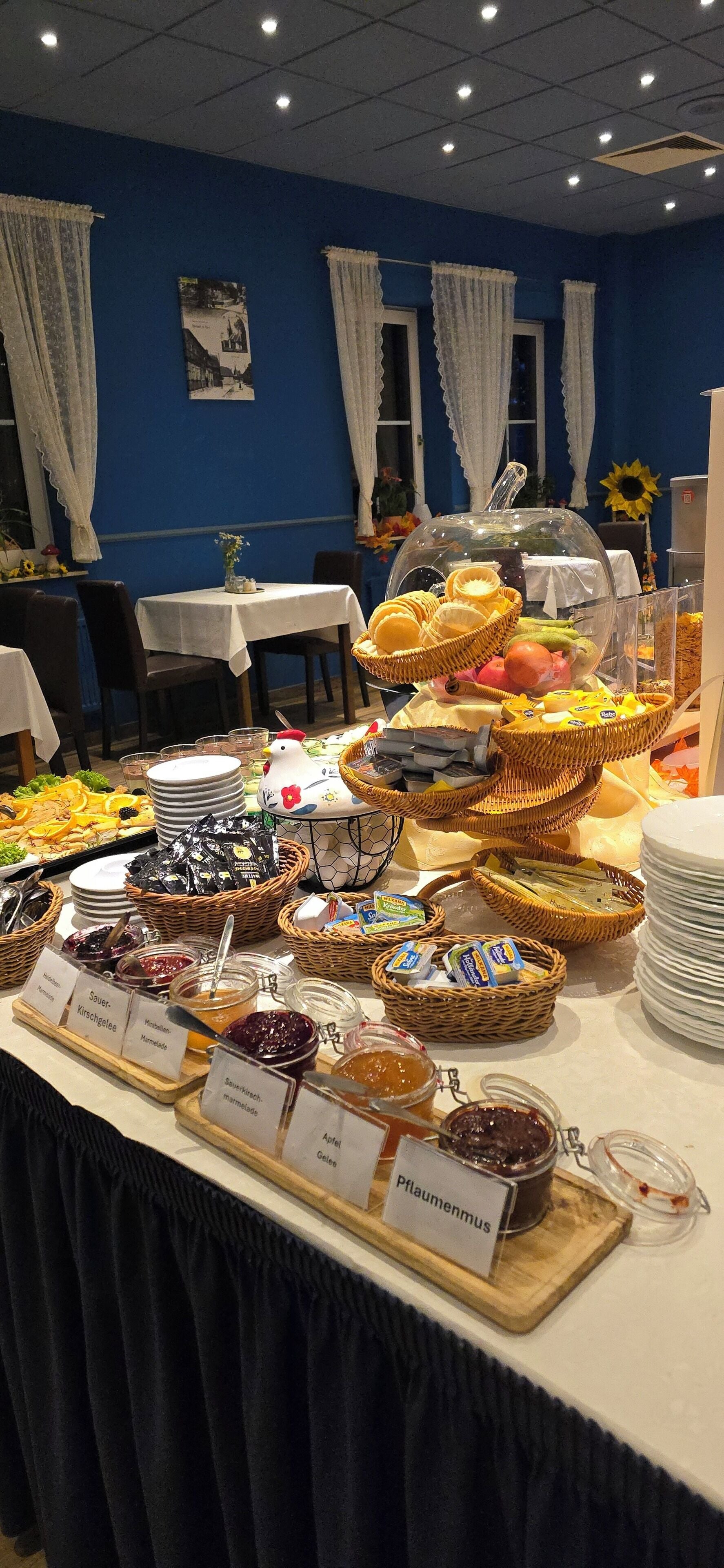 A buffet table with various food items and condiments.