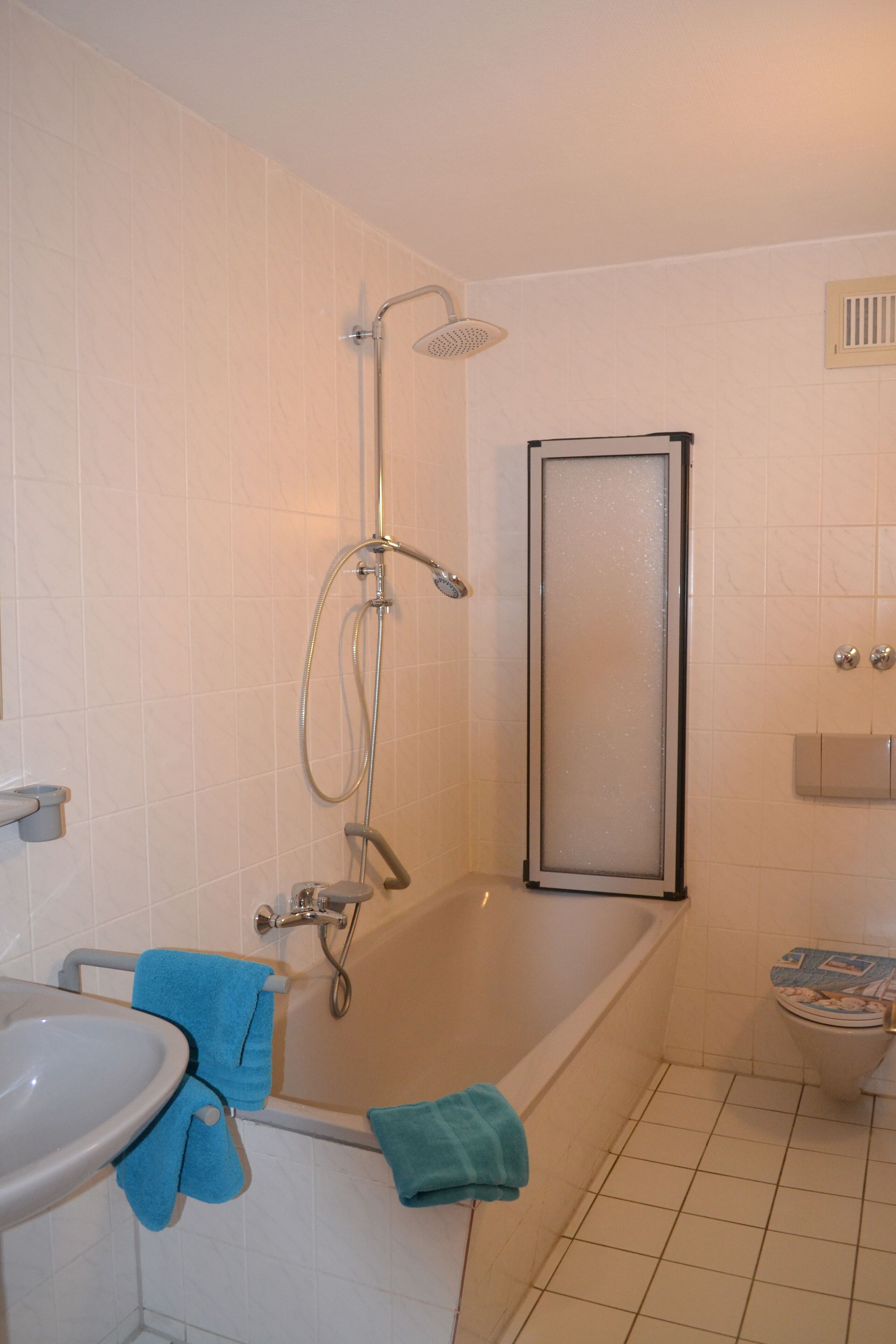 A bathroom with a bathtub, a shower, a toilet, and a sink.
