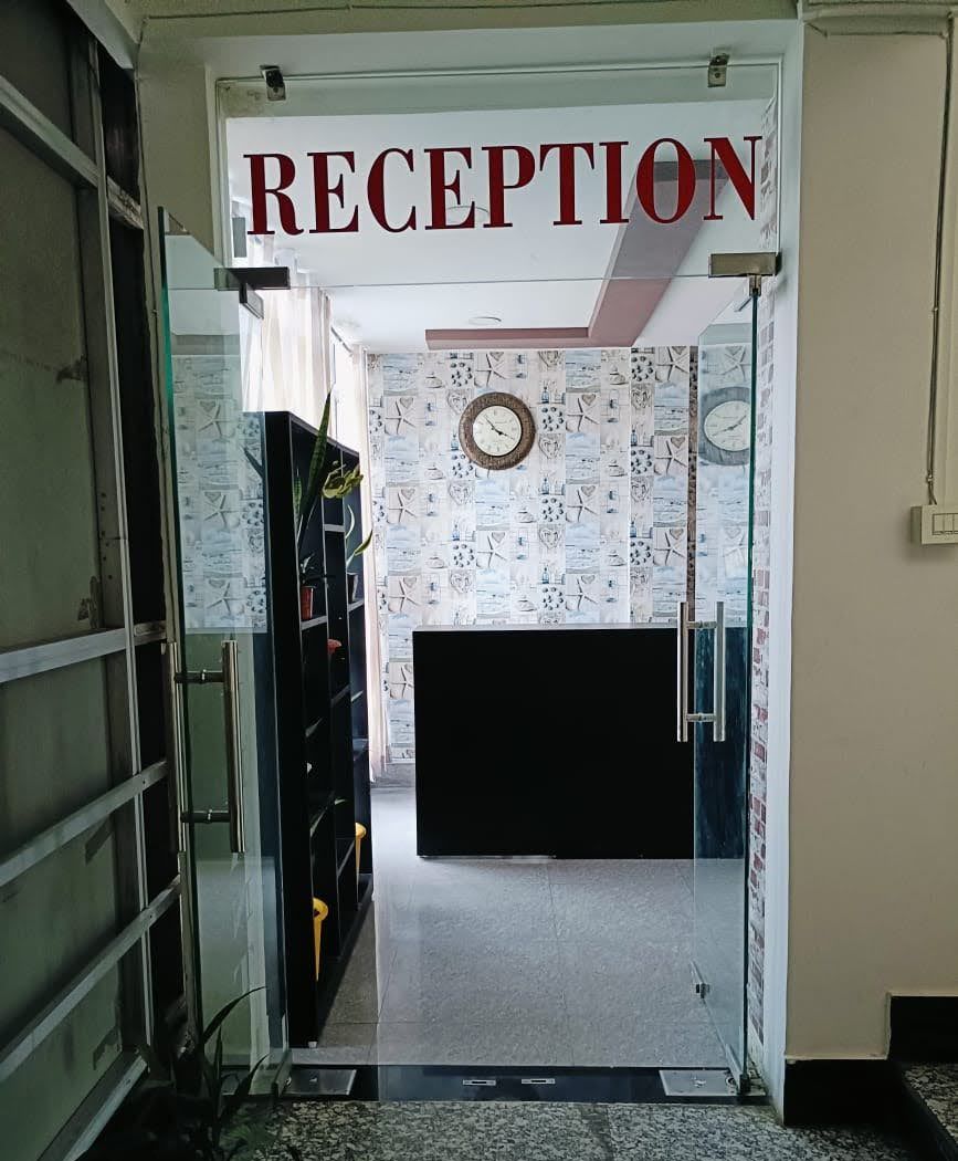 A reception area with a sign reading "RECEPTION" above a doorway.