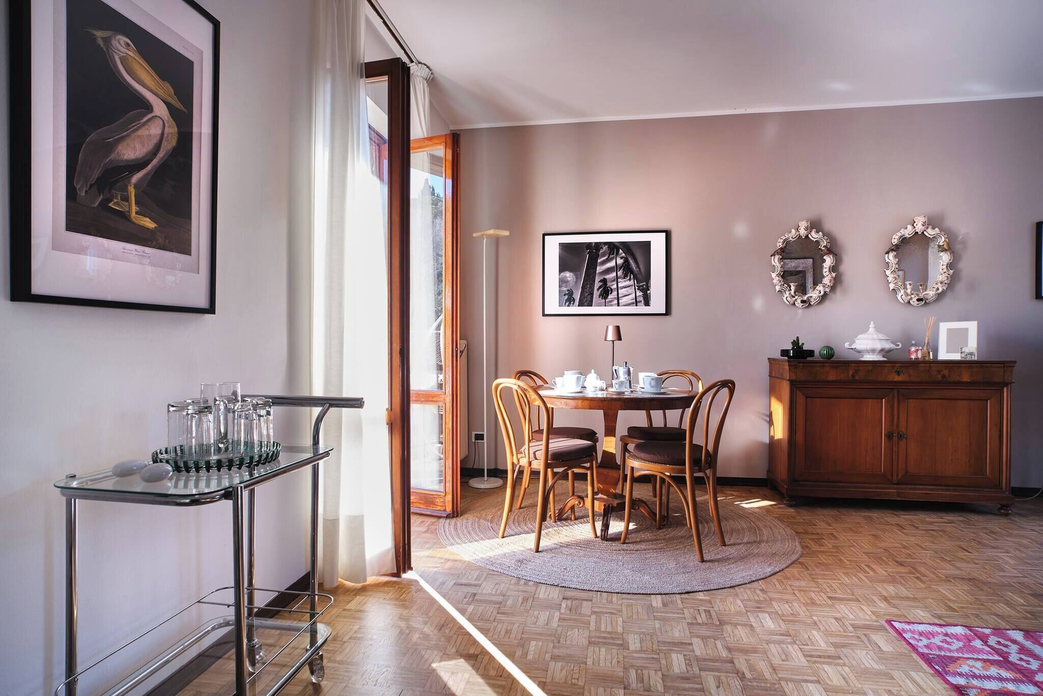 A dining area with a wooden table, chairs, and a cabinet.