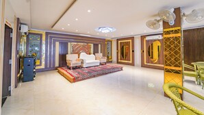 A spacious lobby with a central seating area, a patterned carpet, and a modern ceiling design. - Shiv Rudraksh Resort - Near Assi Ghat (Varanasi)