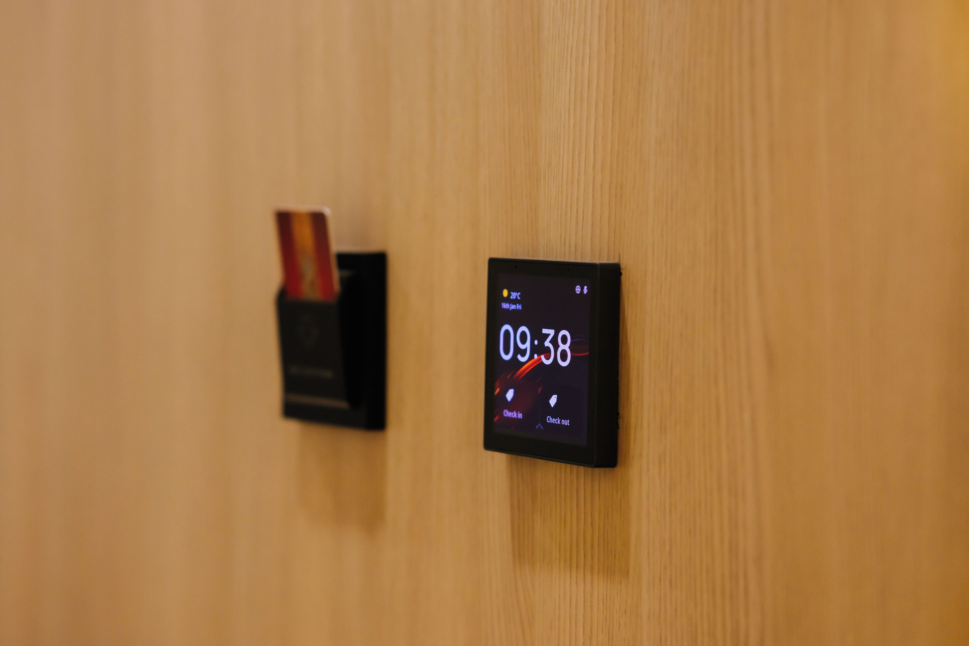A digital clock on a wooden wall displaying the time 09:38.