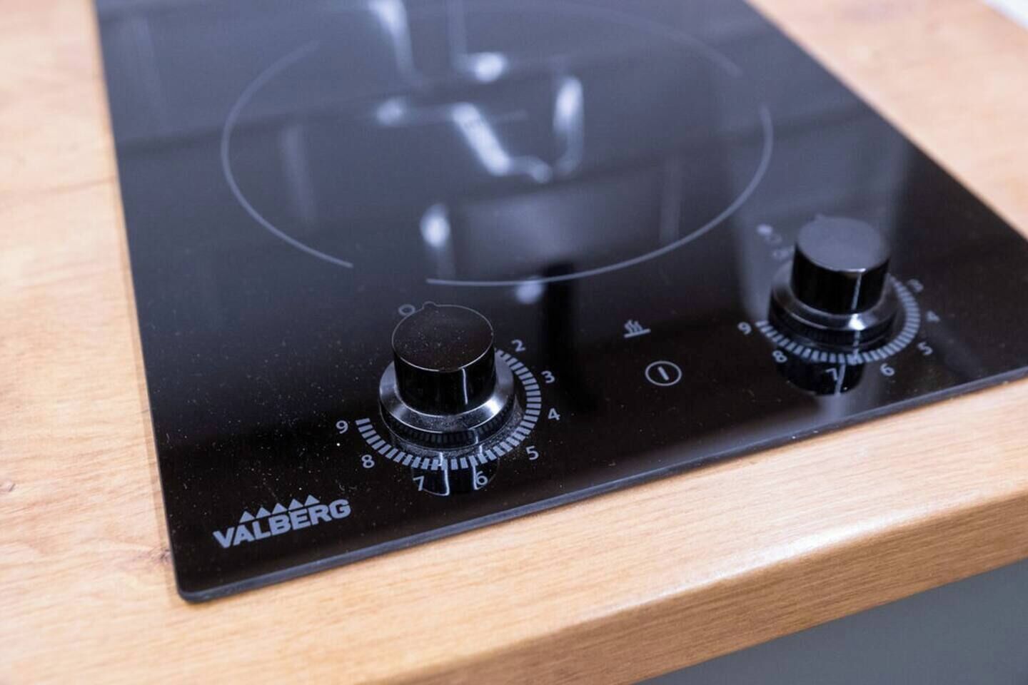 A black induction cooktop with two knobs and a control panel, labeled "VALBERG."