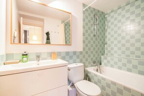 Een haardroger, handdoeken, zeep, toiletpapier