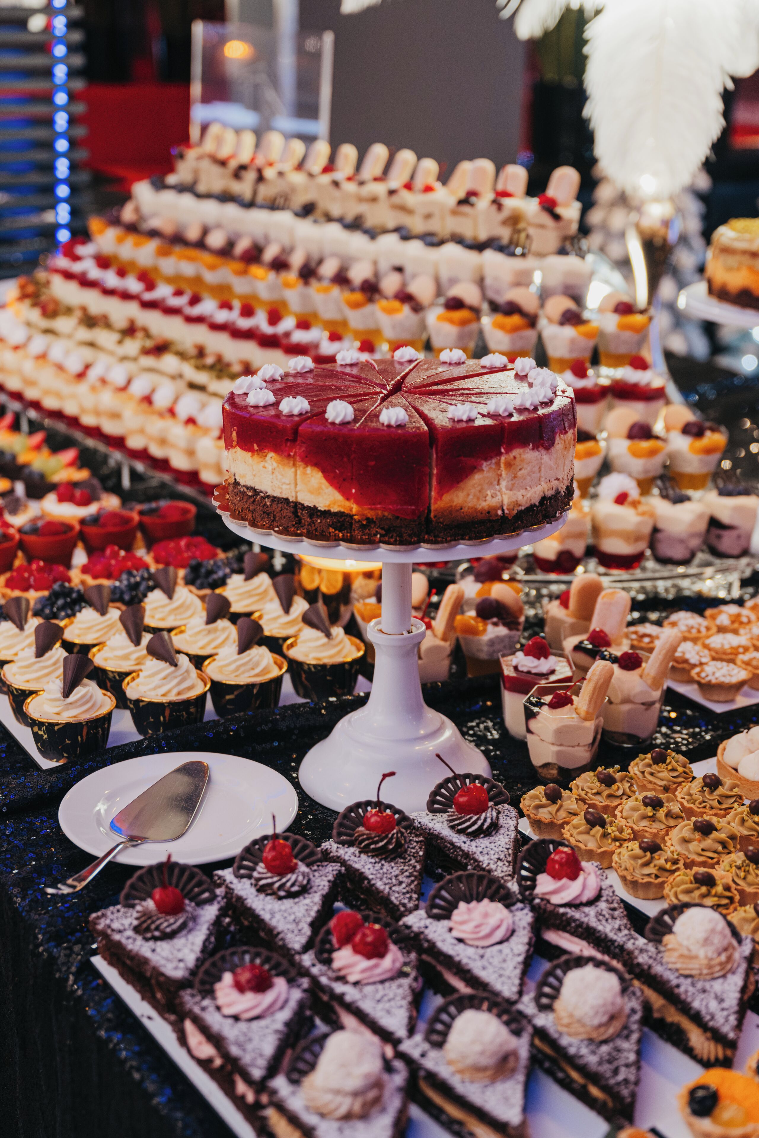 A variety of desserts on display, including cakes, cupcakes, and pastries.