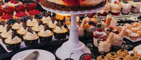 A variety of desserts on display, including cakes, cupcakes, and pastries.